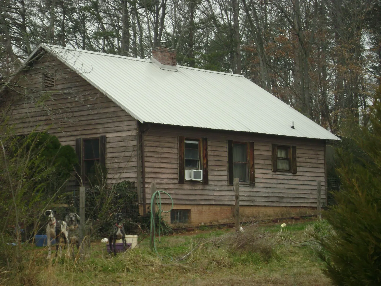 White metal roof on an old wood sided farmhouse, from a Metal Roof Installation job in Gretna